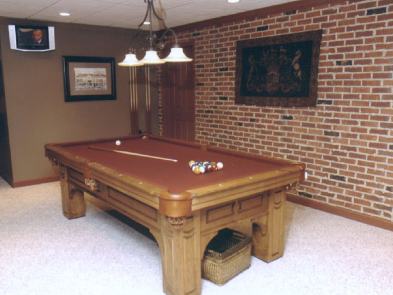 residential interior thin brick wall next to a pool table