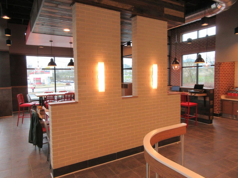 completed thin brick pilasters installed in an Arby's