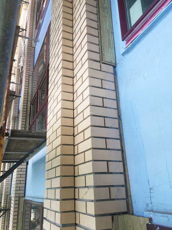 thin brick faux columns being installed